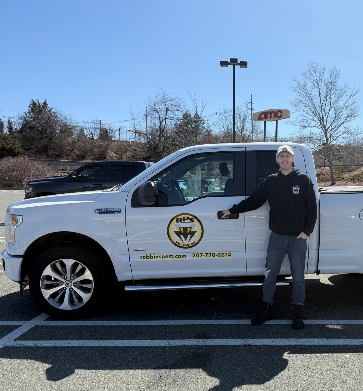 Rick Robbins, Owner of Robbins Pest Services, standing next to his professional pest control truck in Maine